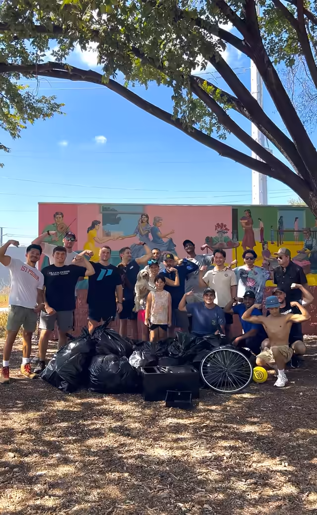 The East Austin community clean up crew with the bags of trash they collected