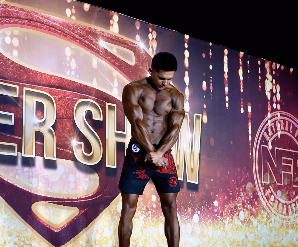 Mark Villanueva Jr. on stage at the NFF Super Show men's physique competition